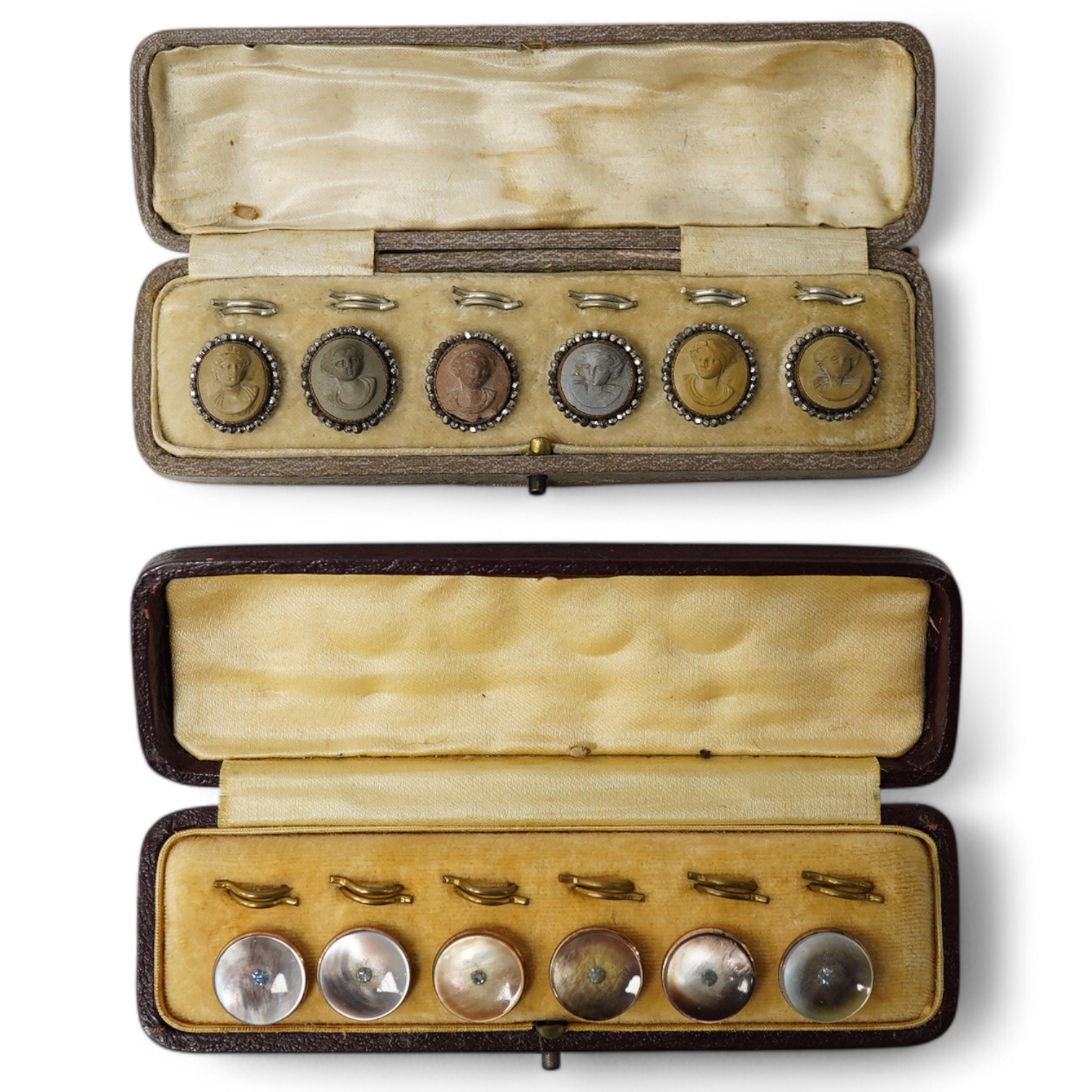 A cased set of 6 late Victorian carved lava buttons with cut steel borders, each carved with a classical female bust, 16mm and a cased set of 6 mother of pearl dress studs with gilt backs., Condition - cut steel border t